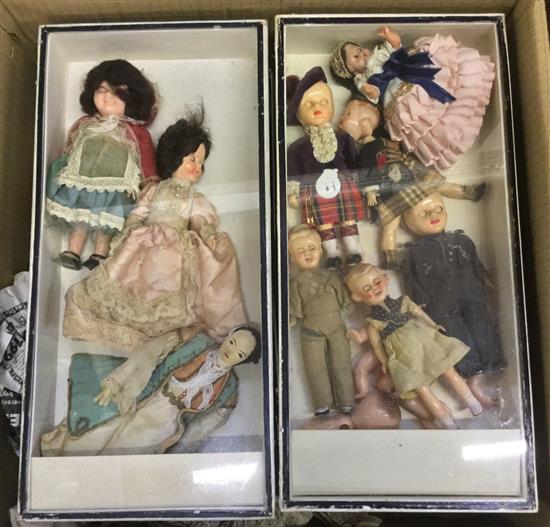 Small dolls in display cases